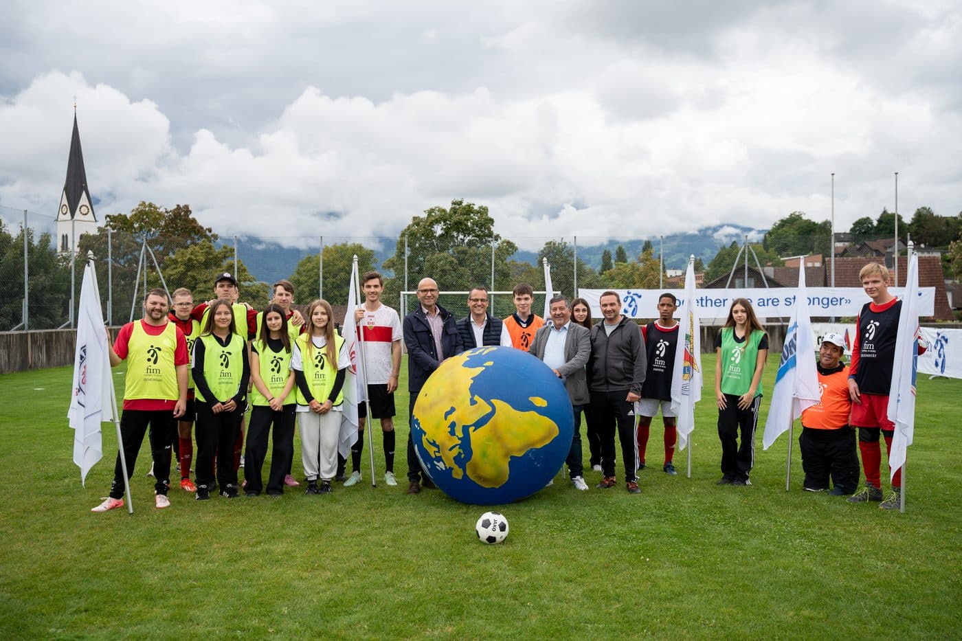 Children with and without disabilities playing football together.