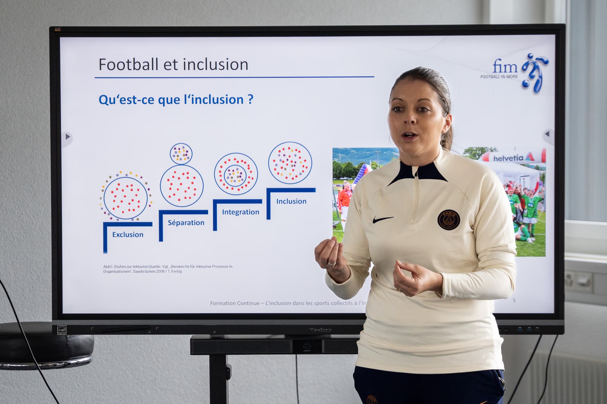 Coach guiding an inclusion-focused team huddle.